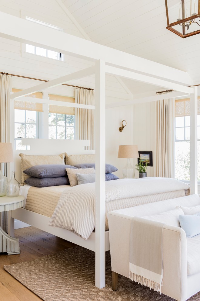 Bedroom - coastal master medium tone wood floor and brown floor bedroom idea in Boston with white walls
