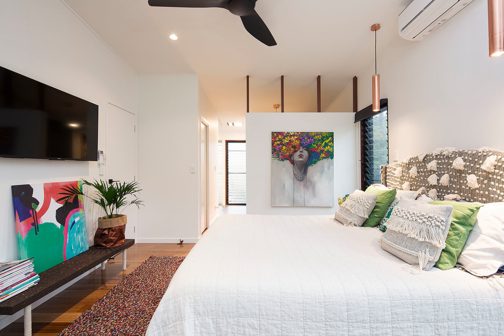 Diseño de dormitorio principal minimalista pequeño con paredes blancas, suelo de madera en tonos medios y suelo multicolor