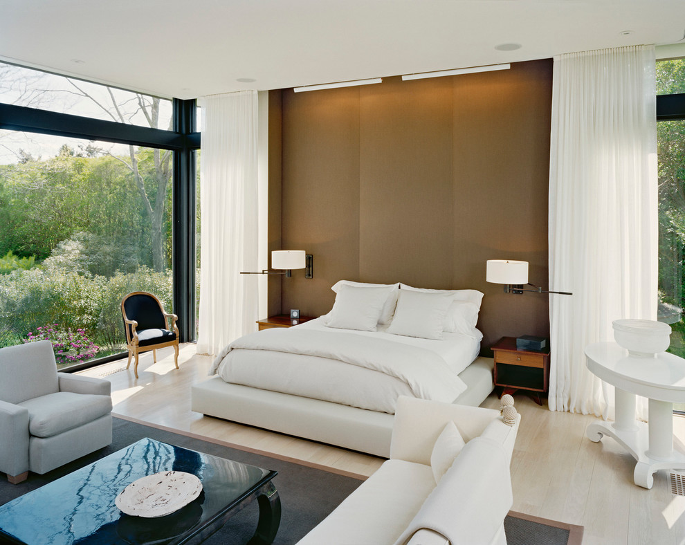 Diseño de dormitorio principal contemporáneo de tamaño medio con paredes marrones y suelo de madera clara
