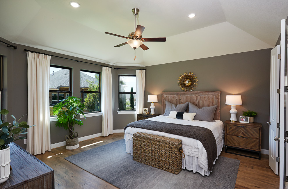 Inspiration for a large transitional master brown floor and bamboo floor bedroom remodel in Other with gray walls