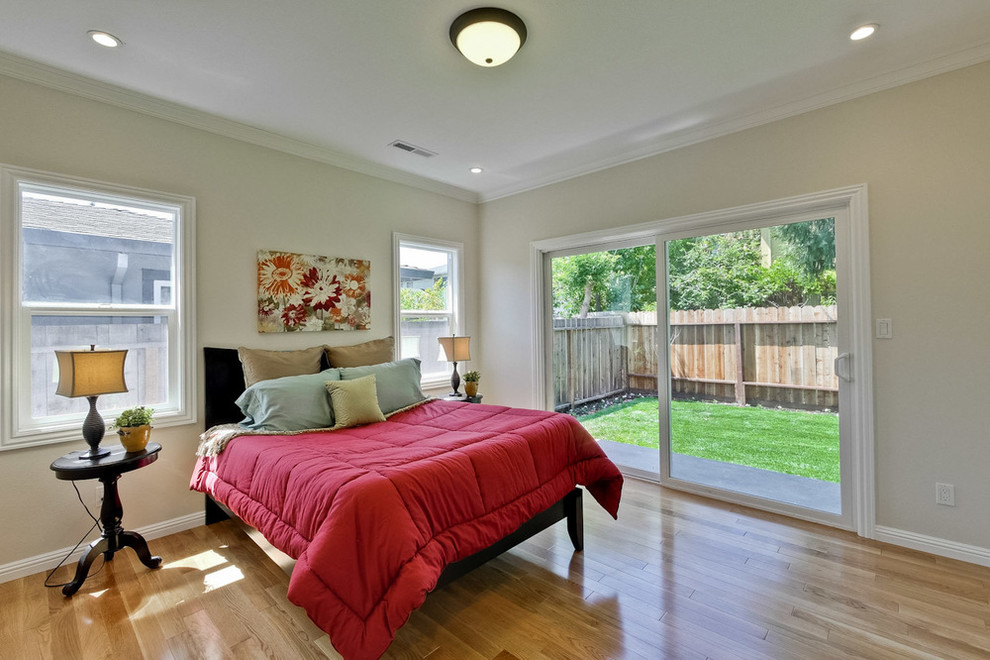 Bedroom - mid-sized contemporary master light wood floor bedroom idea in San Francisco with beige walls
