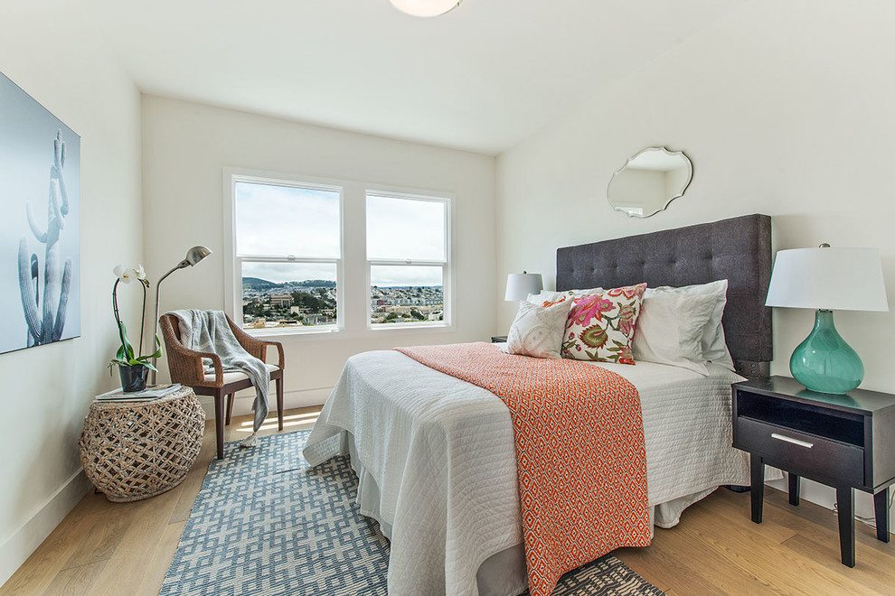 Small traditional guest bedroom in San Francisco with white walls, light hardwood flooring and no fireplace.