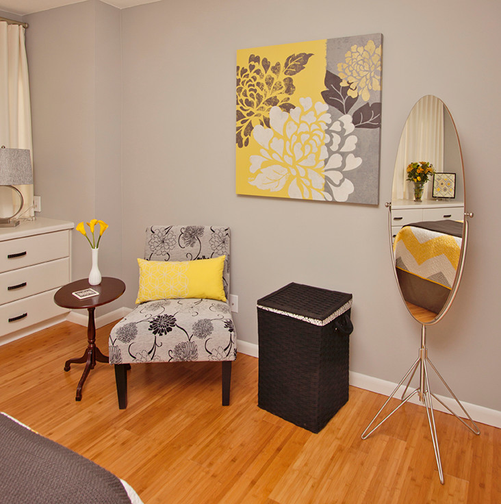 Mid-sized trendy master medium tone wood floor bedroom photo in Kansas City with gray walls and no fireplace