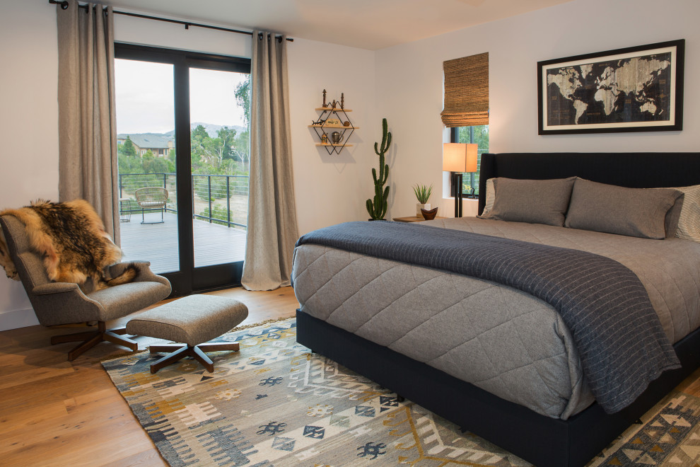 Example of a mid-sized country guest light wood floor and beige floor bedroom design in Orange County with gray walls
