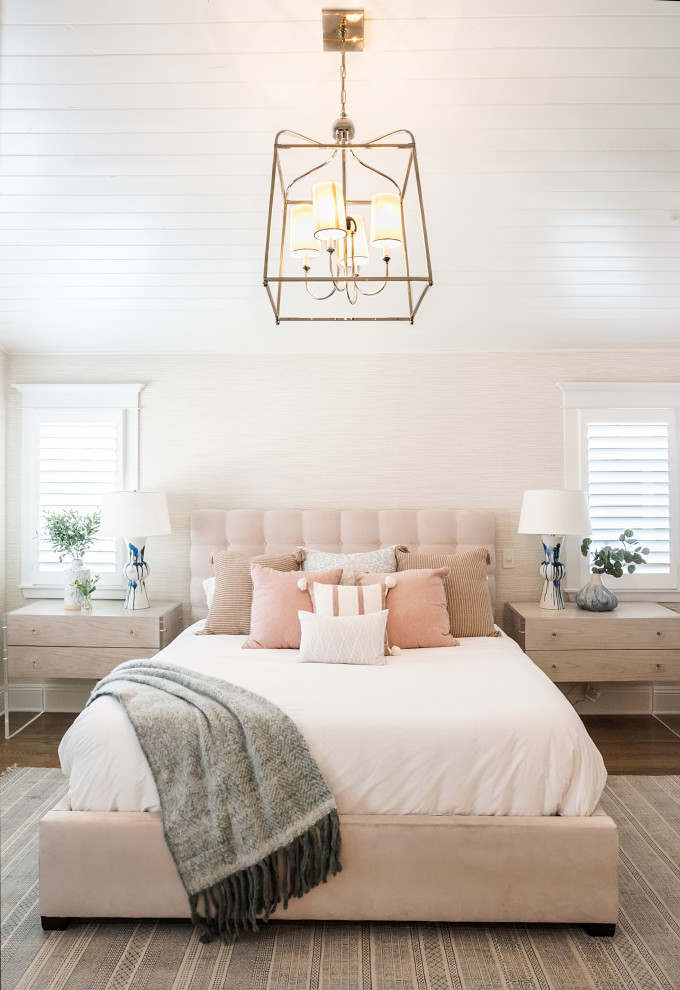 Large beach style master medium tone wood floor and brown floor bedroom photo in Los Angeles with beige walls