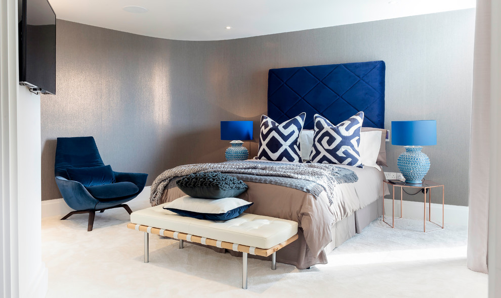 Photo of a contemporary master bedroom in Dorset with grey walls and carpet.