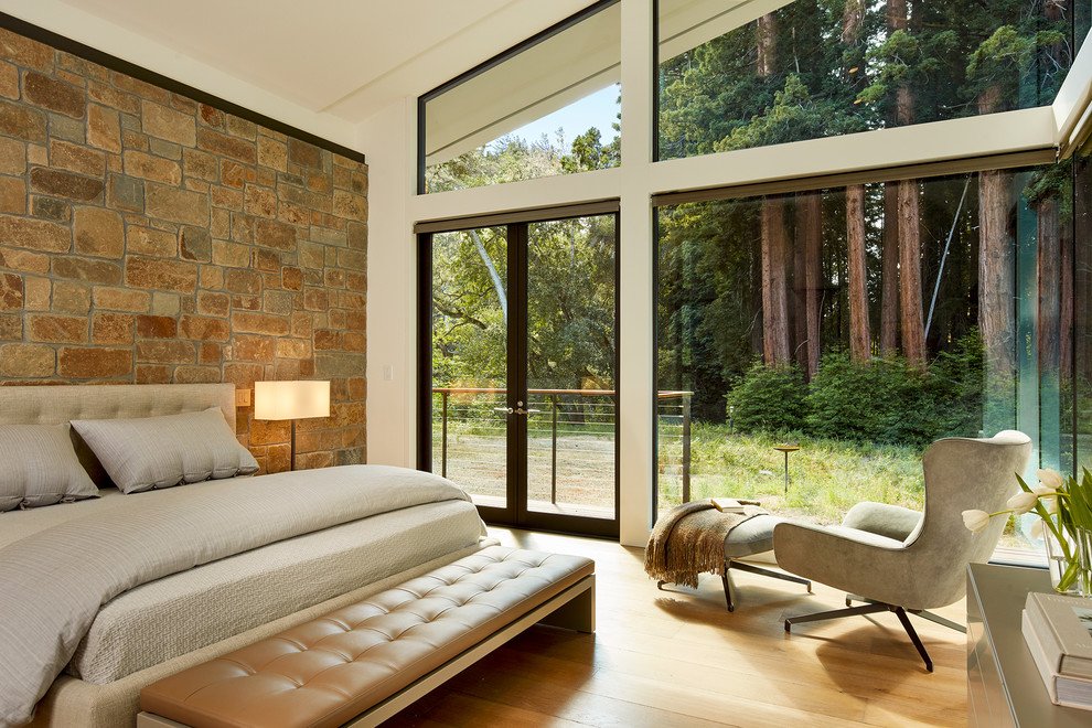 This is an example of a medium sized contemporary master and grey and brown bedroom in Other with white walls, light hardwood flooring, beige floors and no fireplace.