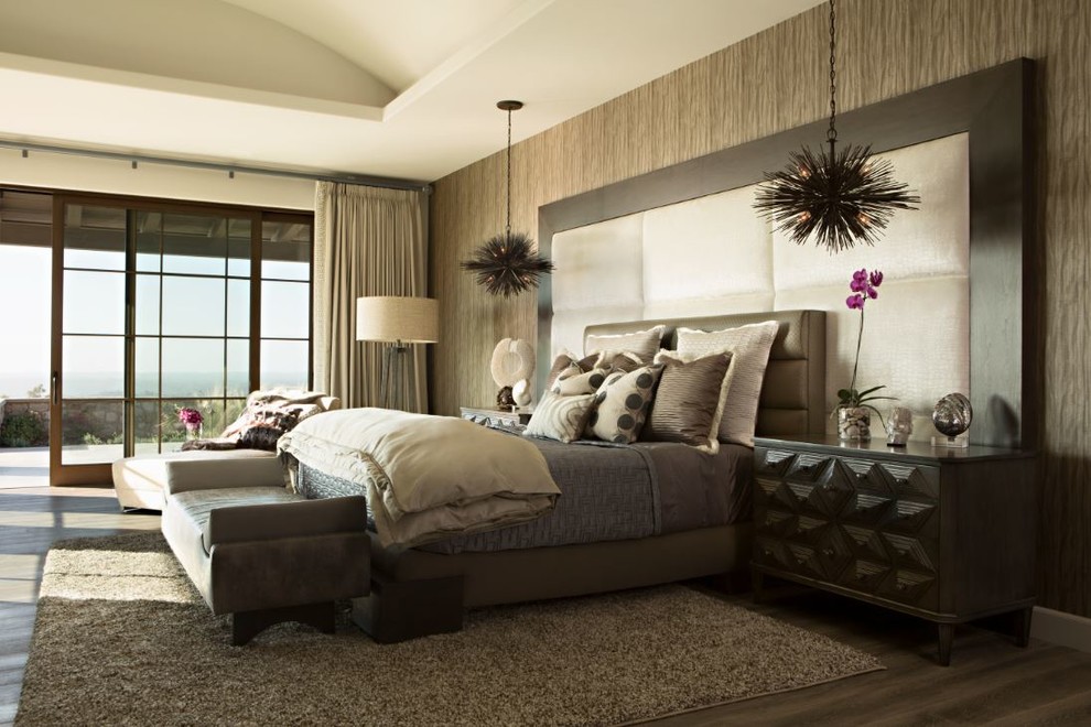 Huge trendy master medium tone wood floor bedroom photo in San Diego with beige walls and a stone fireplace