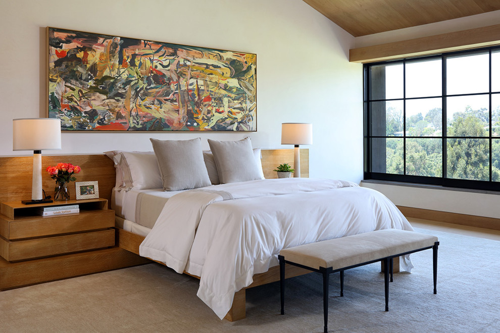 Contemporary master bedroom in Los Angeles with white walls.