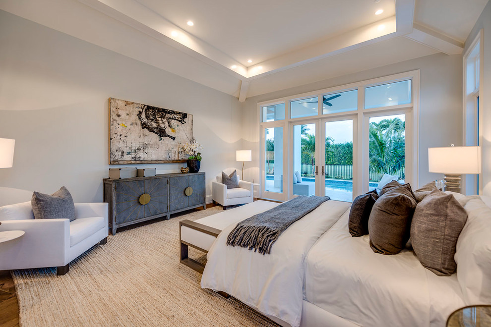 Inspiration for a mid-sized coastal master light wood floor and brown floor bedroom remodel in Other with gray walls