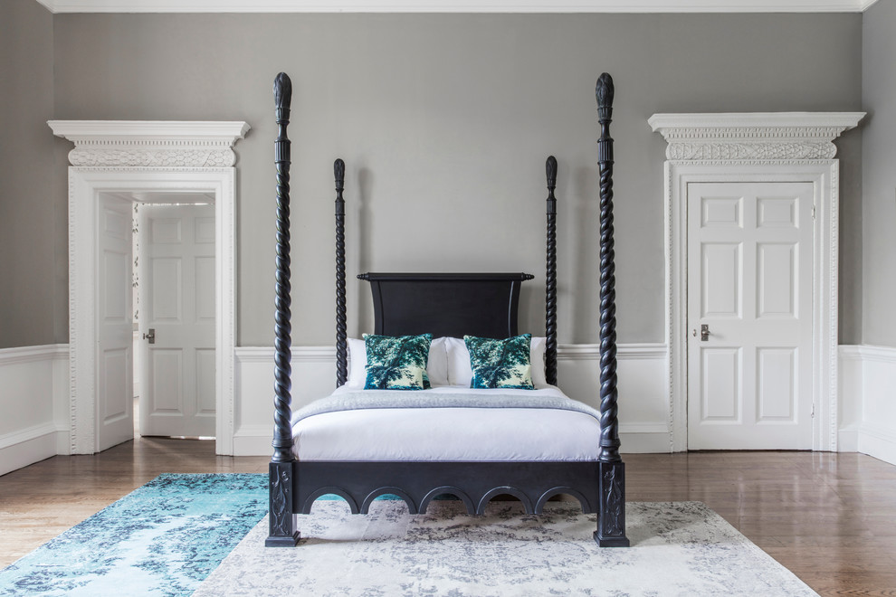 Elegant master dark wood floor bedroom photo in Sussex with gray walls