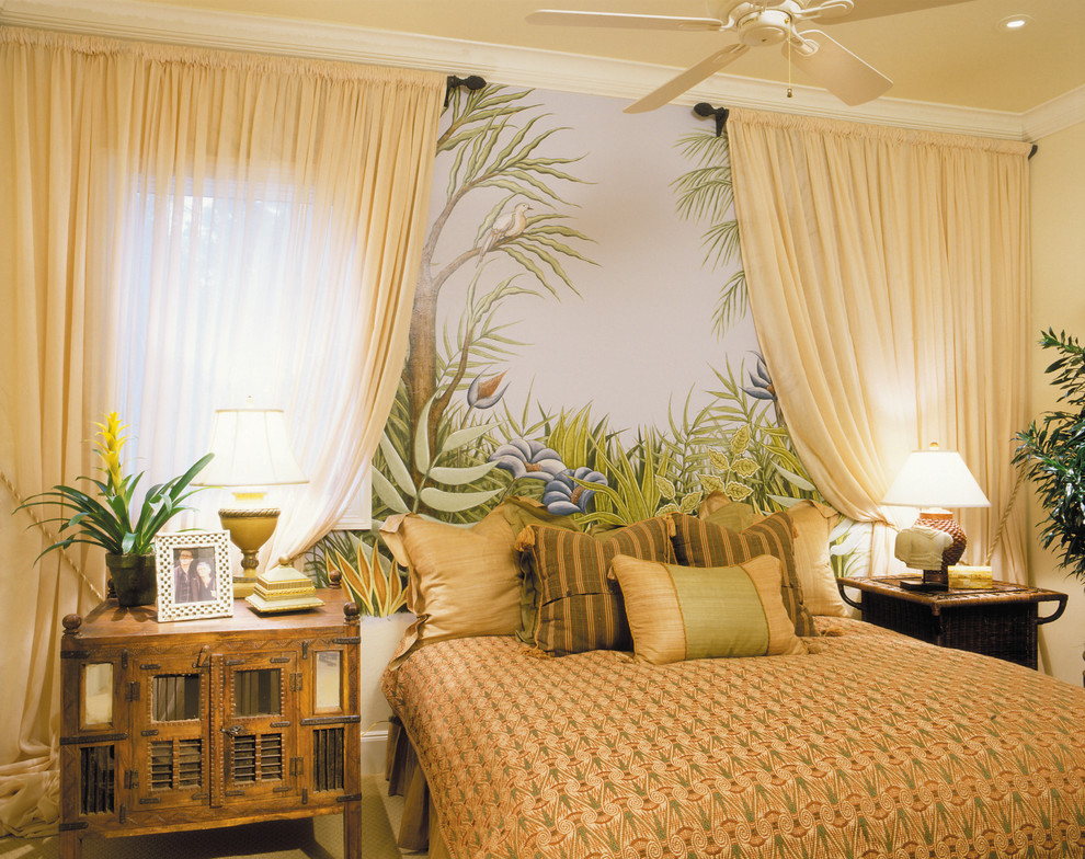 This is an example of a large mediterranean guest bedroom in Miami with beige walls, carpet and no fireplace.
