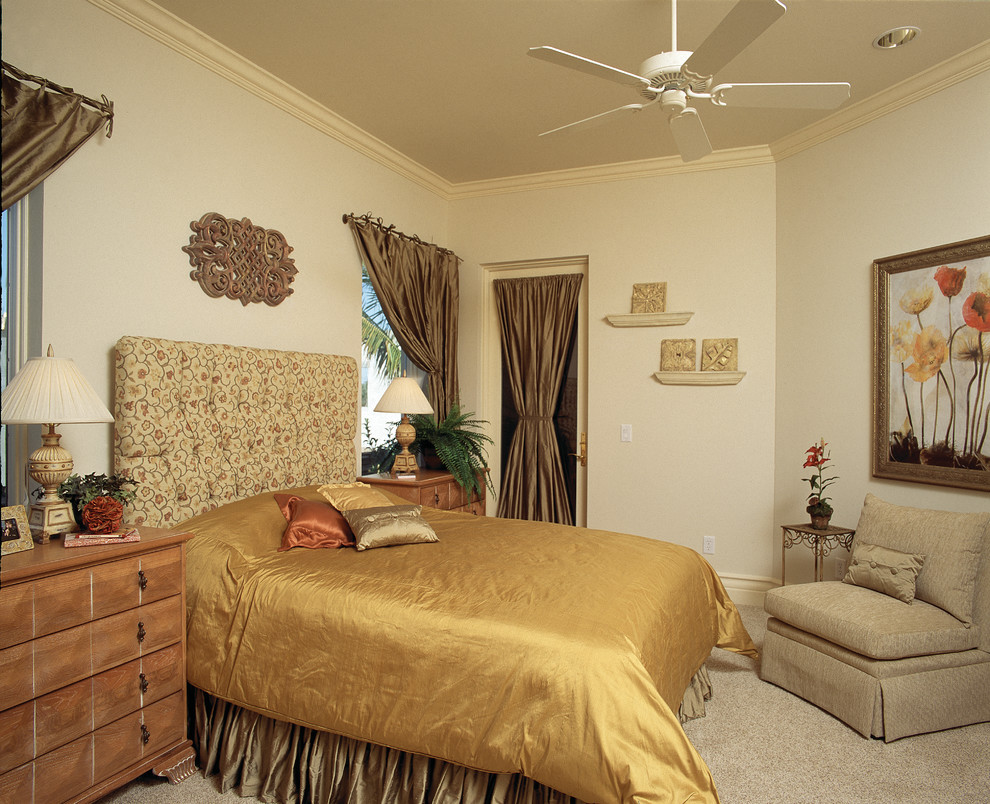 This is an example of a large mediterranean guest bedroom in Miami with beige walls, carpet and no fireplace.