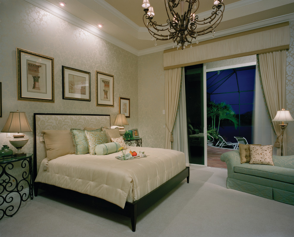 This is an example of a large mediterranean master bedroom in Miami with beige walls, carpet and no fireplace.
