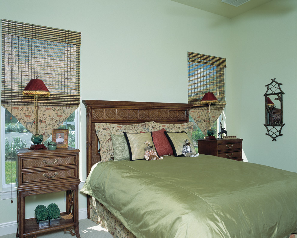 Large mediterranean guest bedroom in Miami with green walls, carpet and no fireplace.