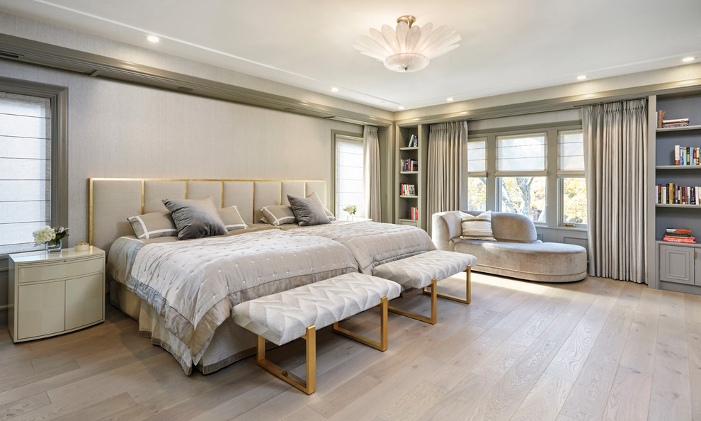 Traditional bedroom in Chicago with grey walls, light hardwood flooring and beige floors.