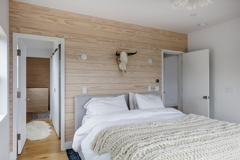 Inspiration for a mid-sized scandinavian master light wood floor and beige floor bedroom remodel in San Francisco with beige walls and no fireplace