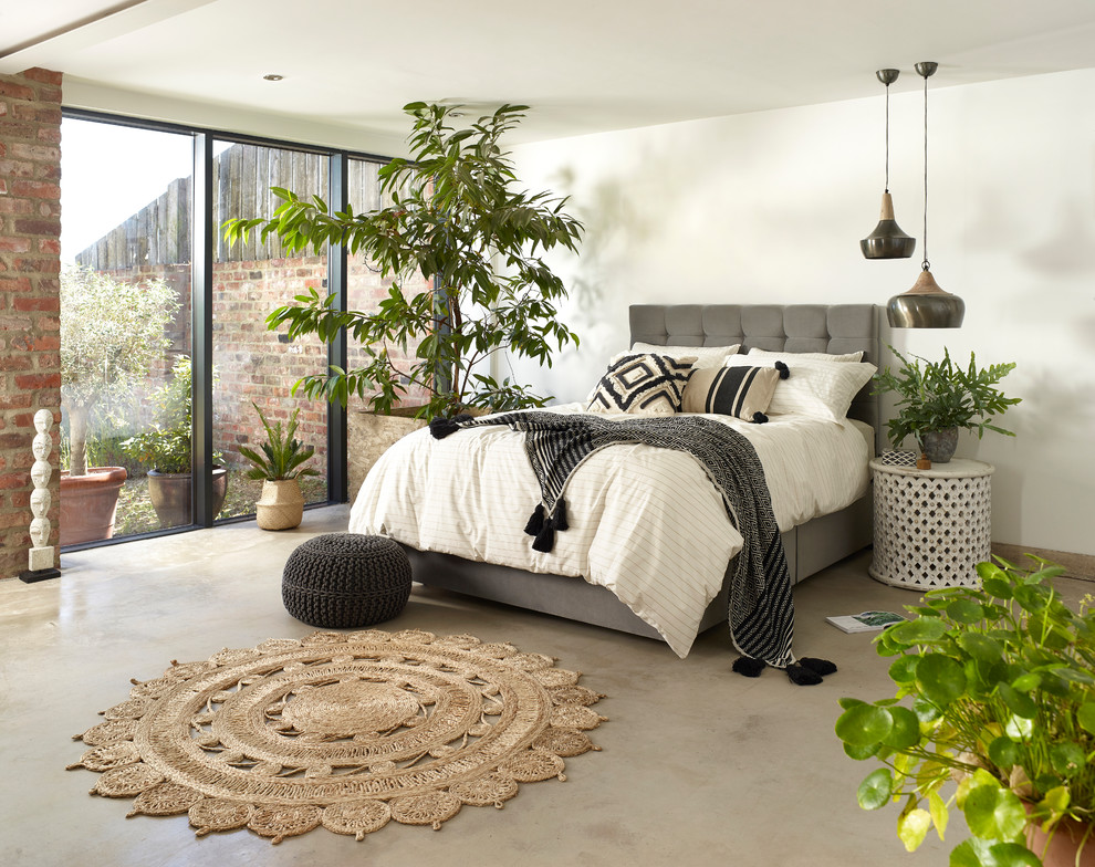 This is an example of a scandinavian grey and brown bedroom in Other with white walls and beige floors.