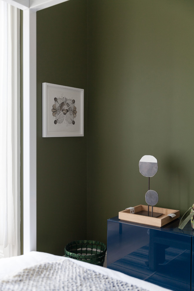Cette image montre une chambre d'amis nordique de taille moyenne avec un mur vert et parquet clair.