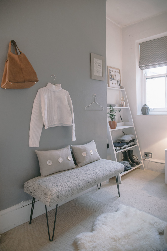Small scandinavian master and grey and cream bedroom in London with grey walls and carpet.