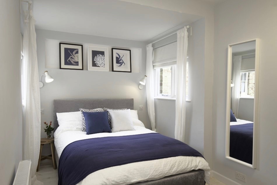 Bedroom - mid-sized scandinavian master light wood floor and white floor bedroom idea in Other with gray walls