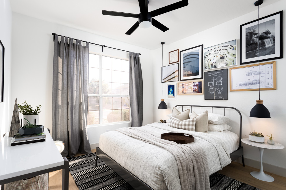 This is an example of a scandi grey and brown bedroom in Phoenix with white walls, medium hardwood flooring and brown floors.