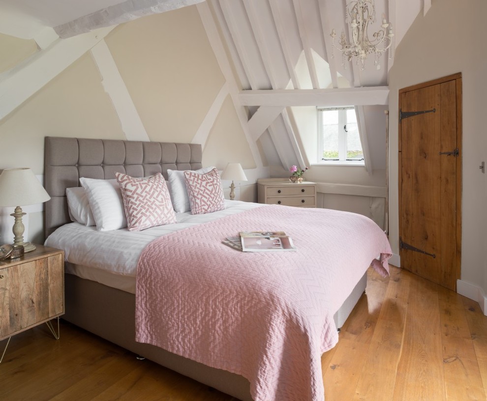 Diseño de dormitorio de estilo de casa de campo de tamaño medio con paredes beige, suelo de madera clara y suelo beige