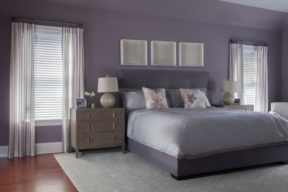 Example of a minimalist medium tone wood floor bedroom design in New York with purple walls