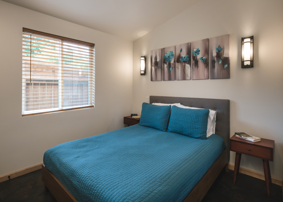 Foto de dormitorio minimalista con suelo de cemento y suelo multicolor