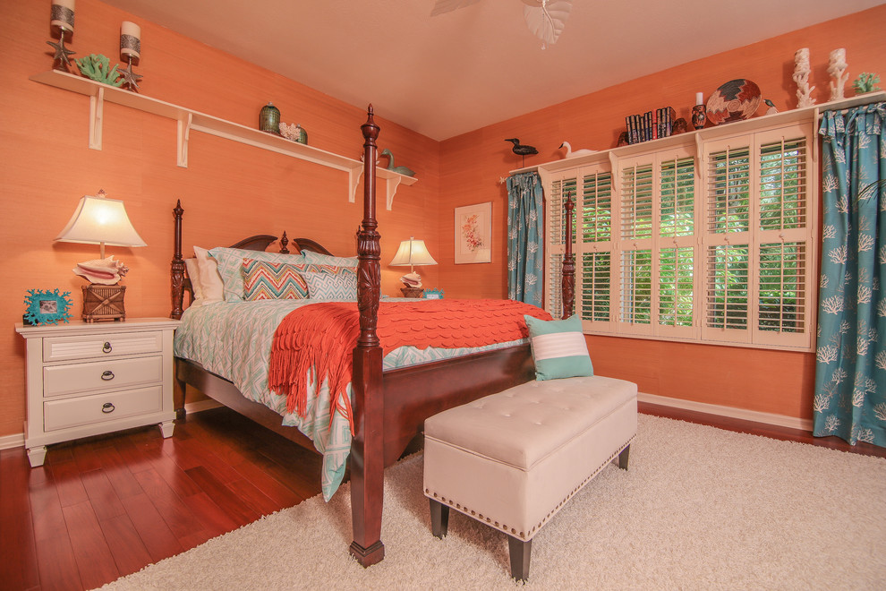 This is an example of a medium sized nautical guest bedroom in Miami with orange walls and medium hardwood flooring.