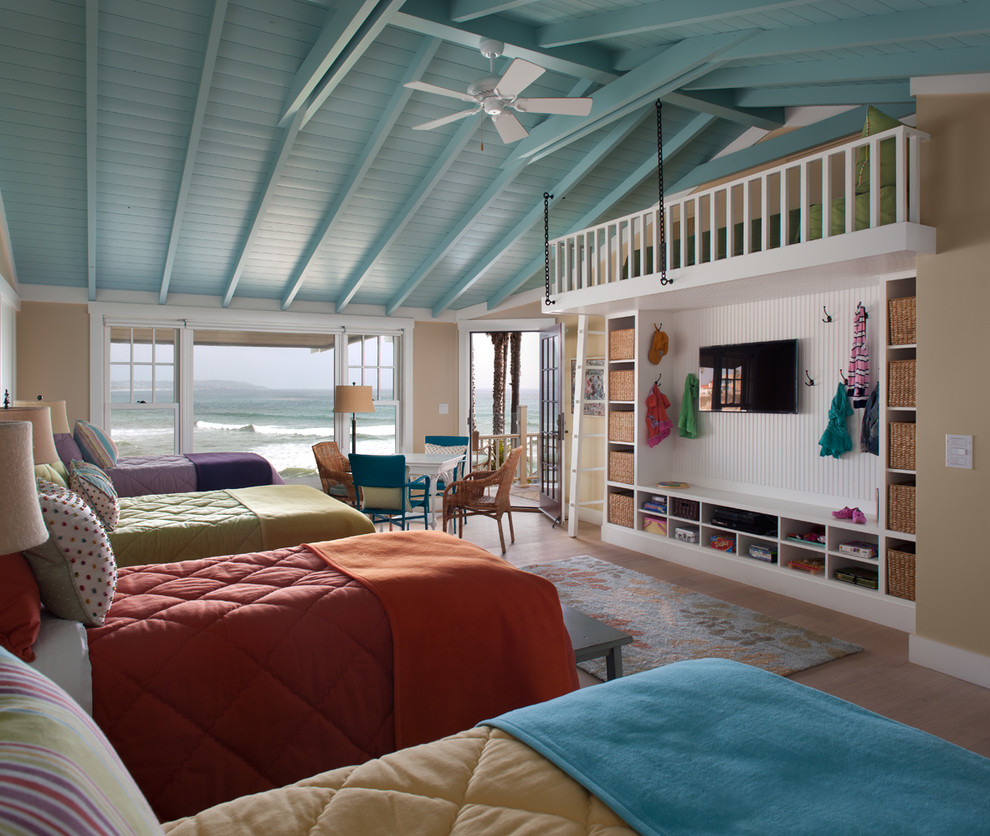 Example of a beach style medium tone wood floor bedroom design in San Diego with beige walls