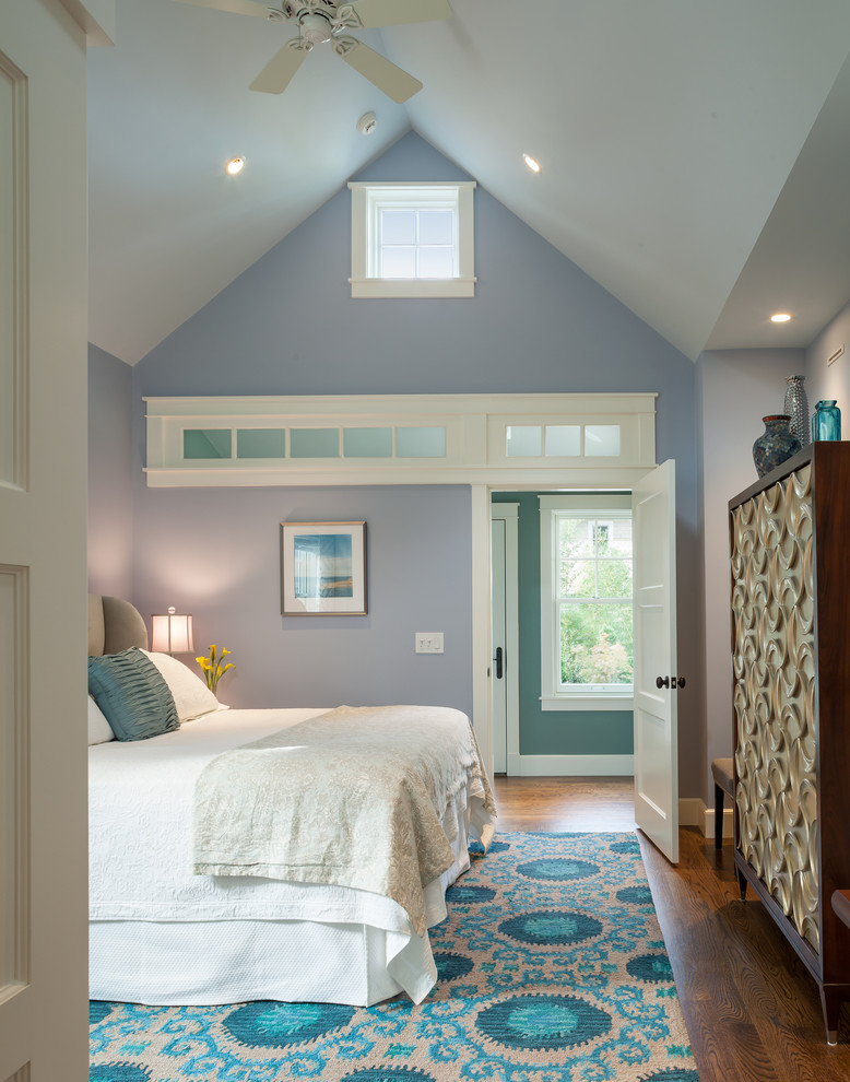 Transitional medium tone wood floor bedroom photo in Providence with blue walls