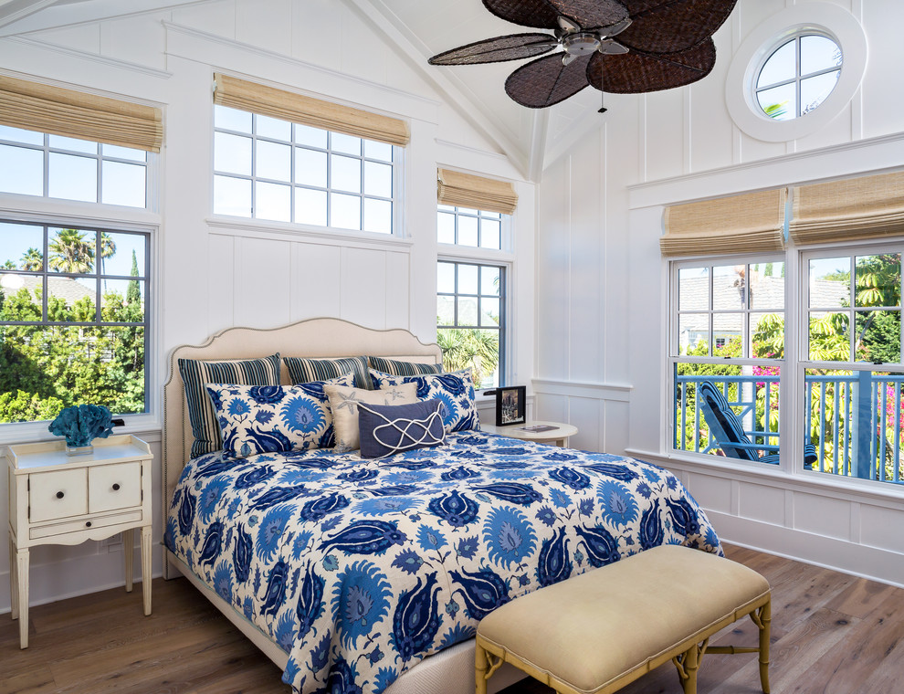 Inspiration for a large beach style master bedroom in San Diego with white walls, light hardwood flooring, no fireplace and beige floors.