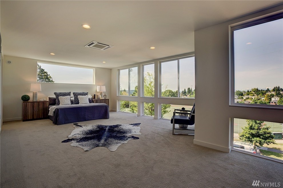 Photo of a large contemporary master bedroom in Seattle with beige walls, carpet, no fireplace and beige floors.