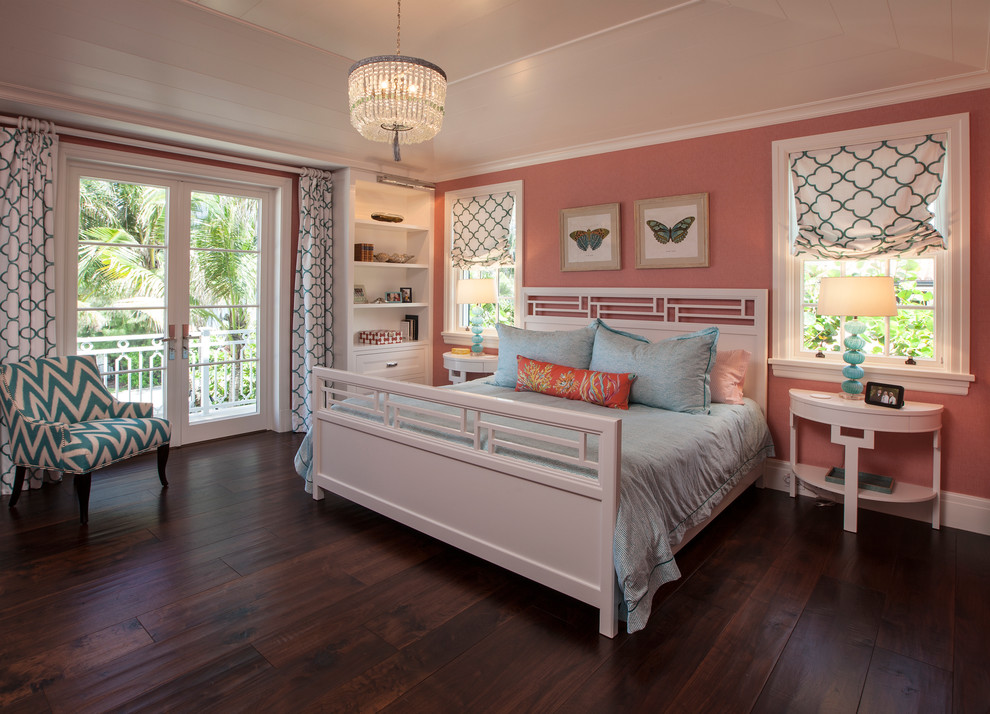 Photo of a large mediterranean guest bedroom in Miami with pink walls, dark hardwood flooring and no fireplace.