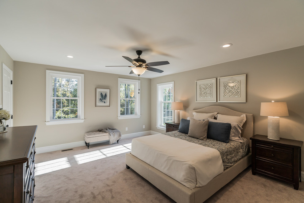 Large traditional master bedroom in Philadelphia with beige walls, carpet and beige floors.