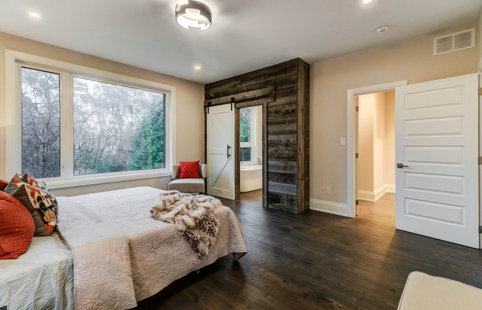 Photo of a medium sized contemporary master bedroom in Toronto with beige walls, medium hardwood flooring, no fireplace and grey floors.