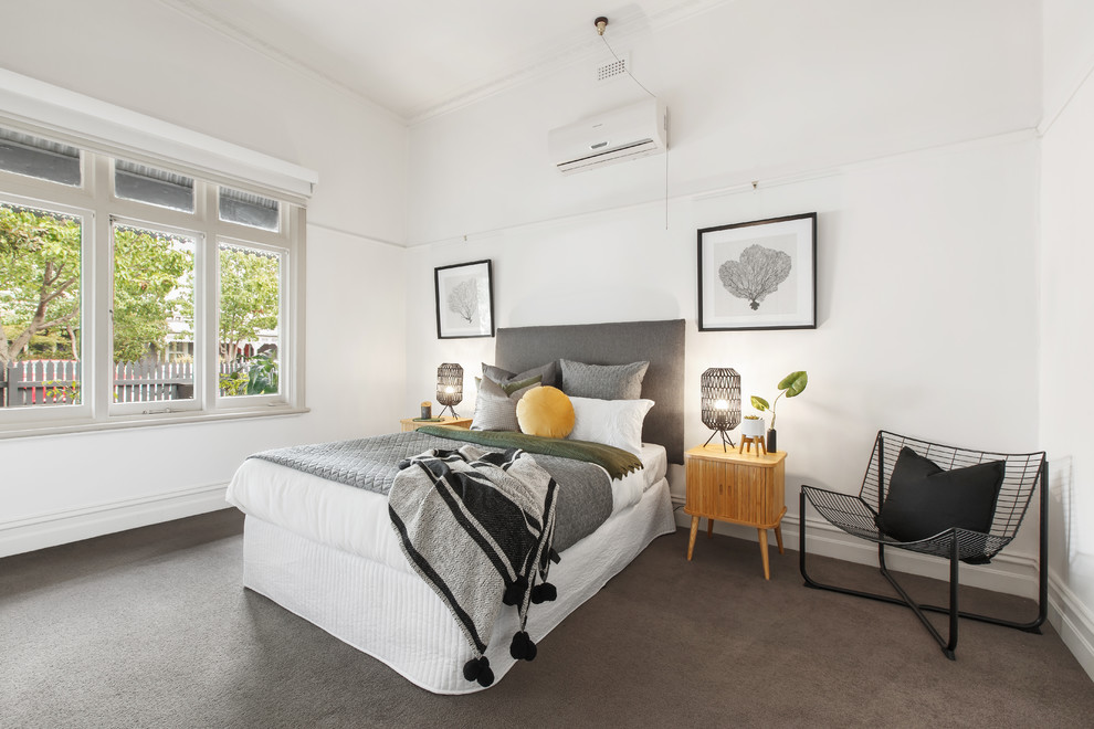 Example of a trendy guest carpeted and gray floor bedroom design in Melbourne with white walls and no fireplace
