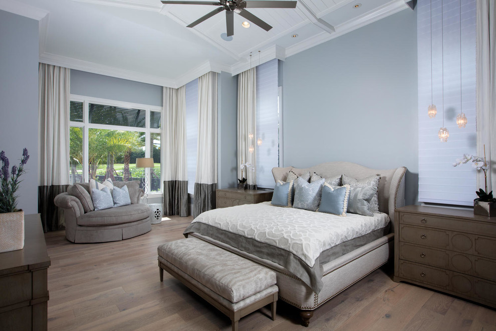 Bedroom - huge transitional master light wood floor and brown floor bedroom idea in Miami with blue walls
