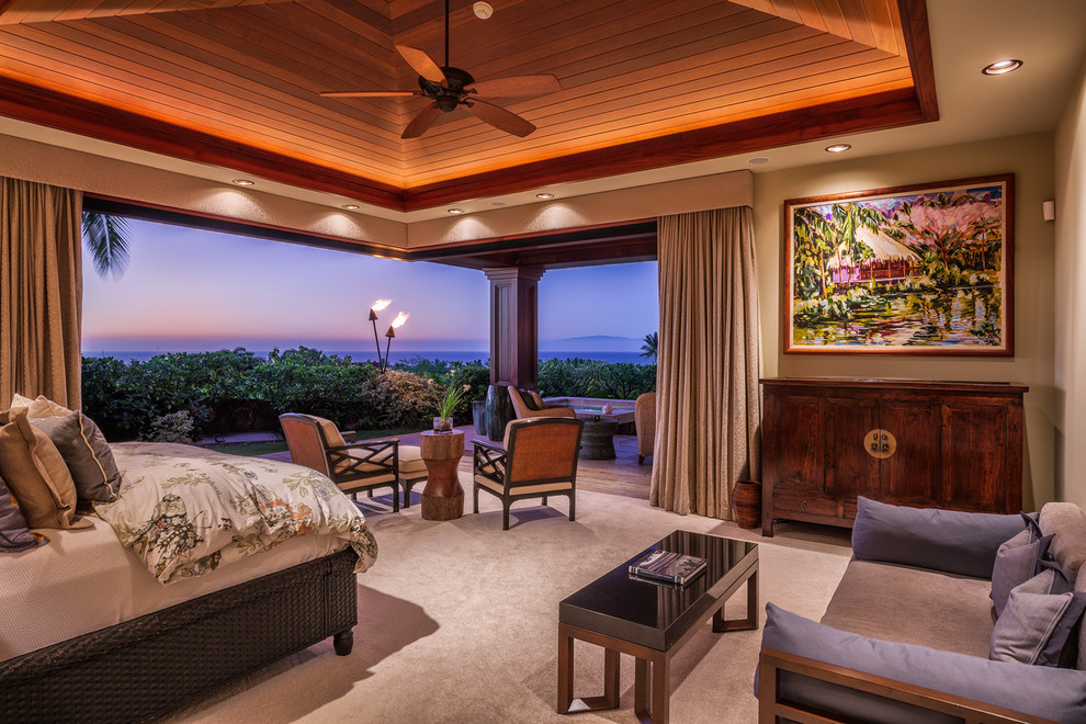Design ideas for a large world-inspired master bedroom in Hawaii with beige walls and carpet.
