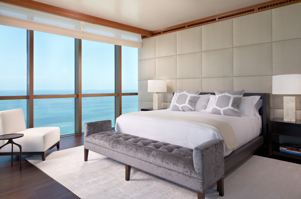 Photo of a contemporary master bedroom in Miami with beige walls and dark hardwood flooring.