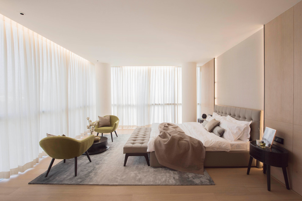 Imagen de dormitorio contemporáneo con paredes beige, suelo de madera clara y suelo beige