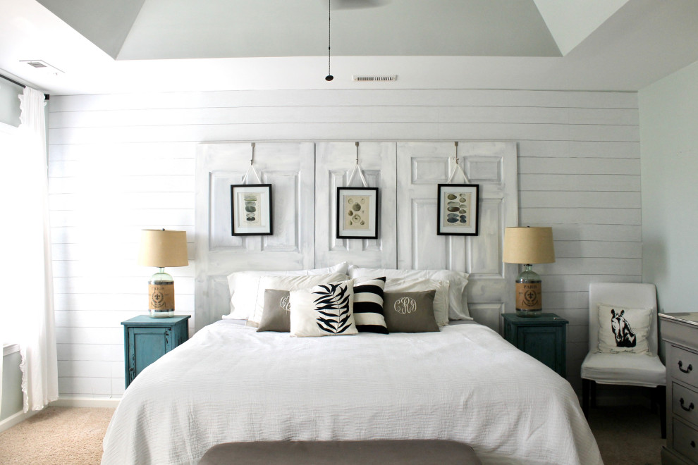 Large shabby-chic style master bedroom in Charlotte with white walls, carpet, beige floors and wallpapered walls.