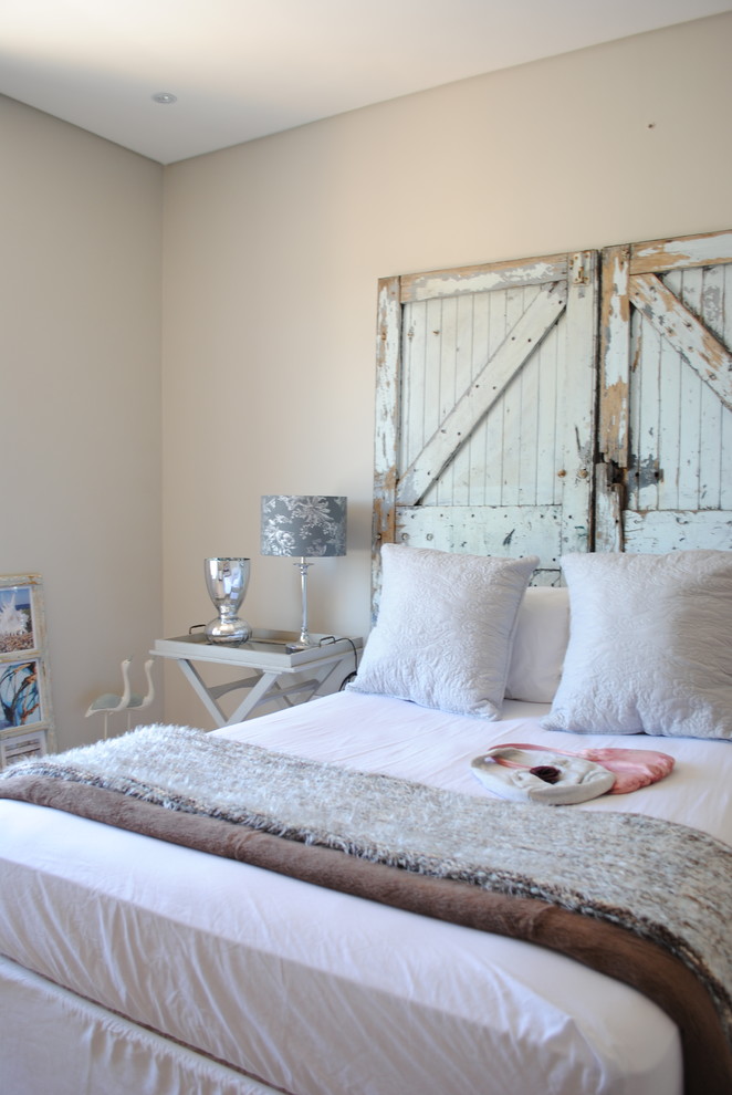 This is an example of a shabby-chic style grey and brown bedroom in Other with beige walls.
