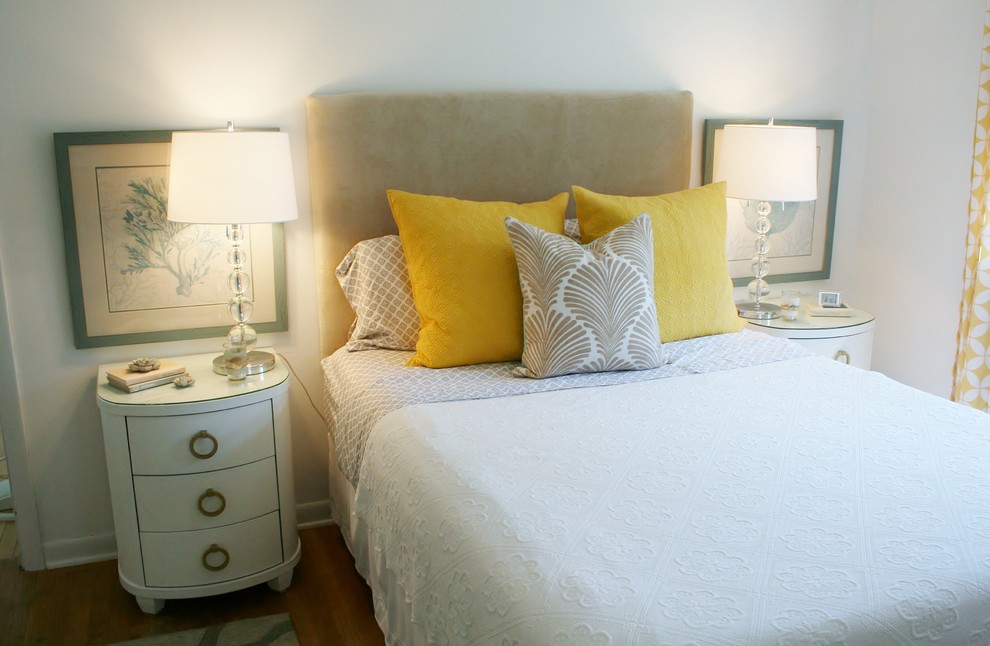 Imagen de dormitorio principal clásico renovado pequeño sin chimenea con paredes blancas y suelo de madera en tonos medios