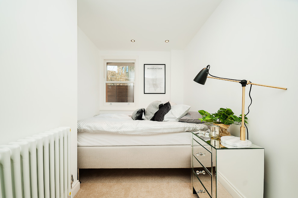 Design ideas for a traditional bedroom in London with white walls, carpet and no fireplace.