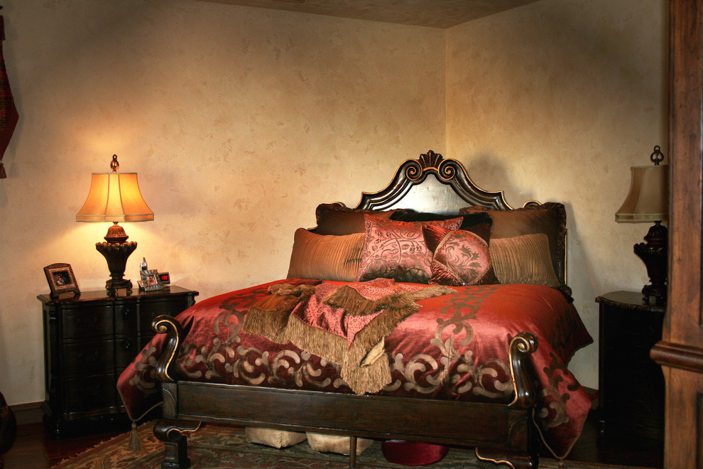 Design ideas for a medium sized mediterranean master bedroom in Austin with beige walls and dark hardwood flooring.
