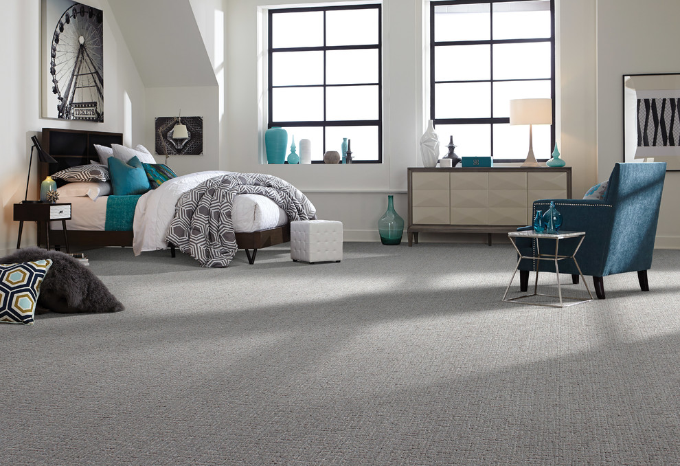 Example of a mid-sized trendy loft-style carpeted and gray floor bedroom design in Other with white walls
