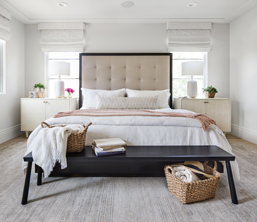 Example of a mid-sized transitional guest light wood floor and beige floor bedroom design in Orange County with white walls