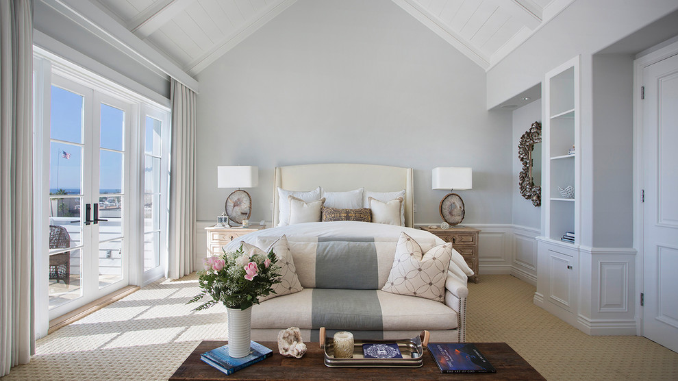 This is an example of a coastal bedroom in Los Angeles with grey walls, carpet and beige floors.